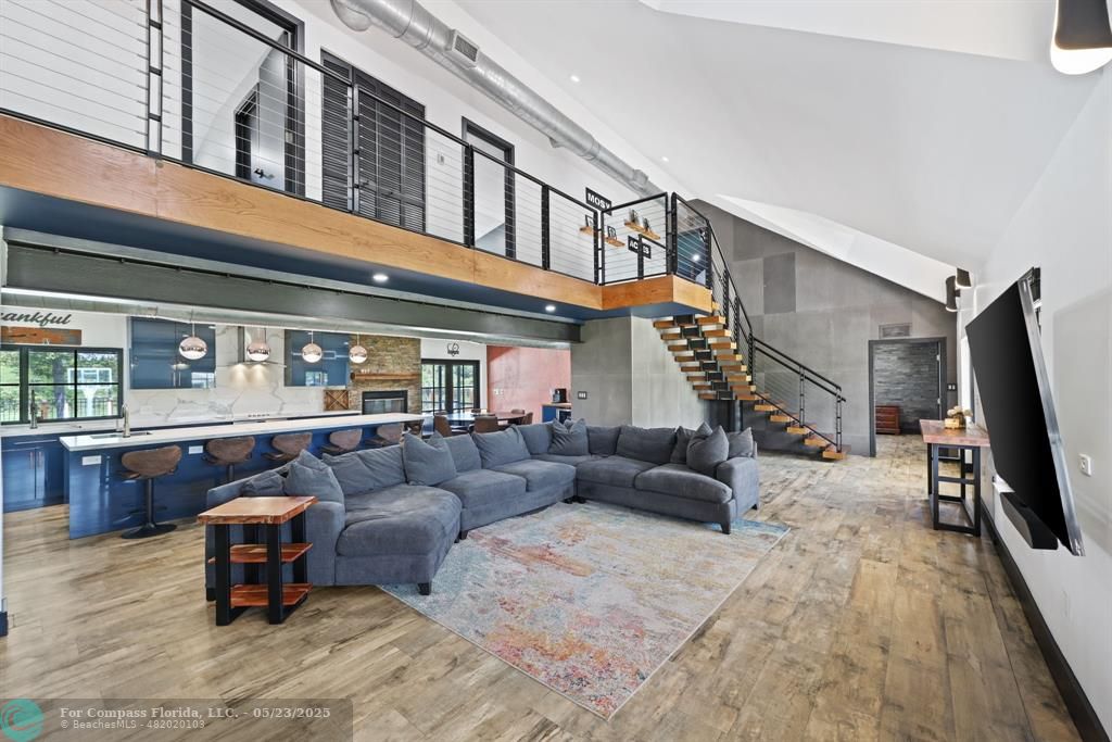 17531 Southwest 68th Court Southwest Ranches, FL 33331 - Photo 11 of 59 a living room with furniture a flat screen tv and a large window