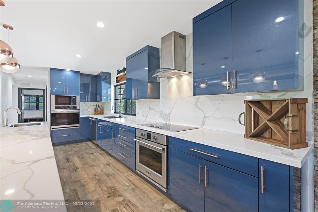 17531 Southwest 68th Court Southwest Ranches, FL 33331 - Photo 15 of 59 a large kitchen with stainless steel appliances wooden cabinets and a stove top oven