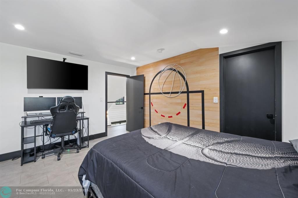 17531 Southwest 68th Court Southwest Ranches, FL 33331 - Photo 29 of 59 a bedroom with a bed and a flat screen tv