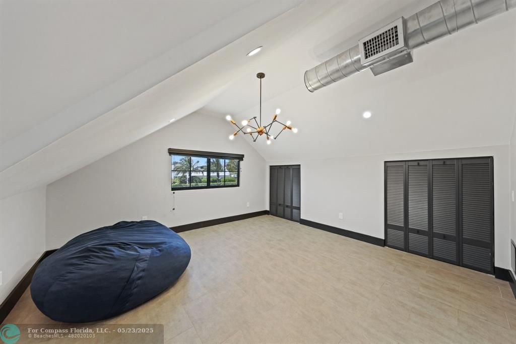 17531 Southwest 68th Court Southwest Ranches, FL 33331 - Photo 34 of 59 a living room with furniture and a chandelier