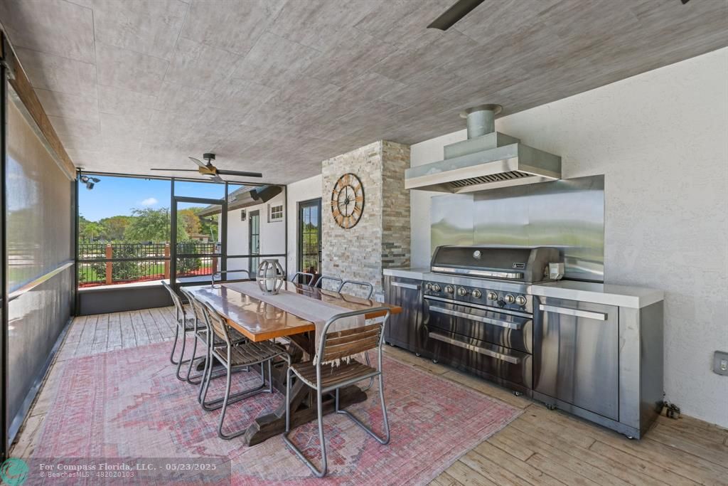 17531 Southwest 68th Court Southwest Ranches, FL 33331 - Photo 40 of 59 a dining hall with stainless steel appliances granite countertop a stove and a sink