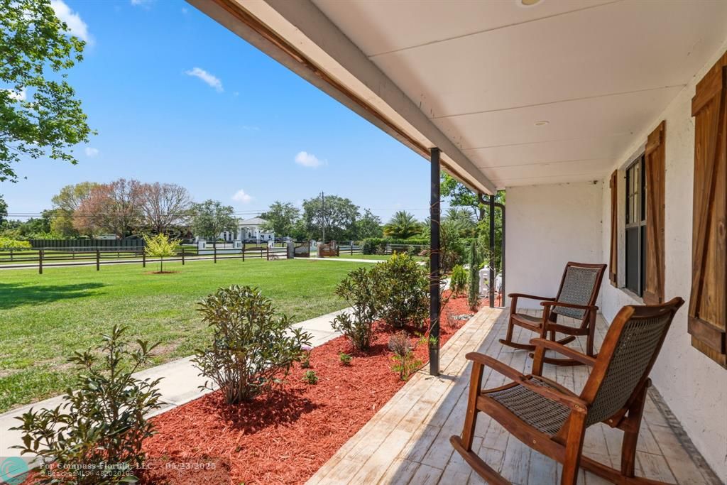 17531 Southwest 68th Court Southwest Ranches, FL 33331 - Photo 5 of 59 a view of a chairs and backyard with large trees