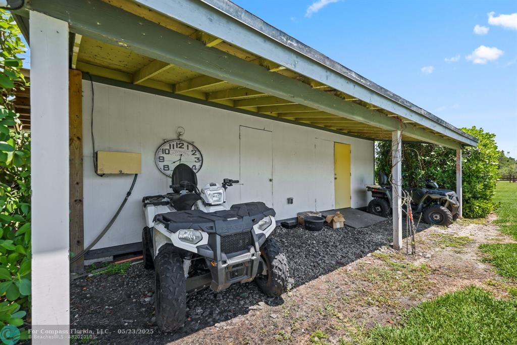 17531 Southwest 68th Court Southwest Ranches, FL 33331 - Photo 57 of 59 a table and chairs in front of a door