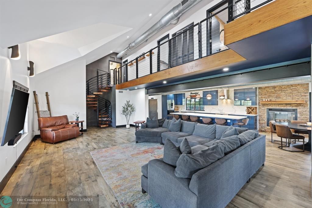 17531 Southwest 68th Court Southwest Ranches, FL 33331 - Photo 8 of 59 a living room with furniture a fireplace and a large window