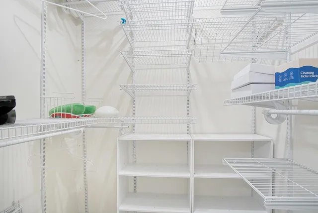 a view of a swimming pool with lawn chairs under an umbrella