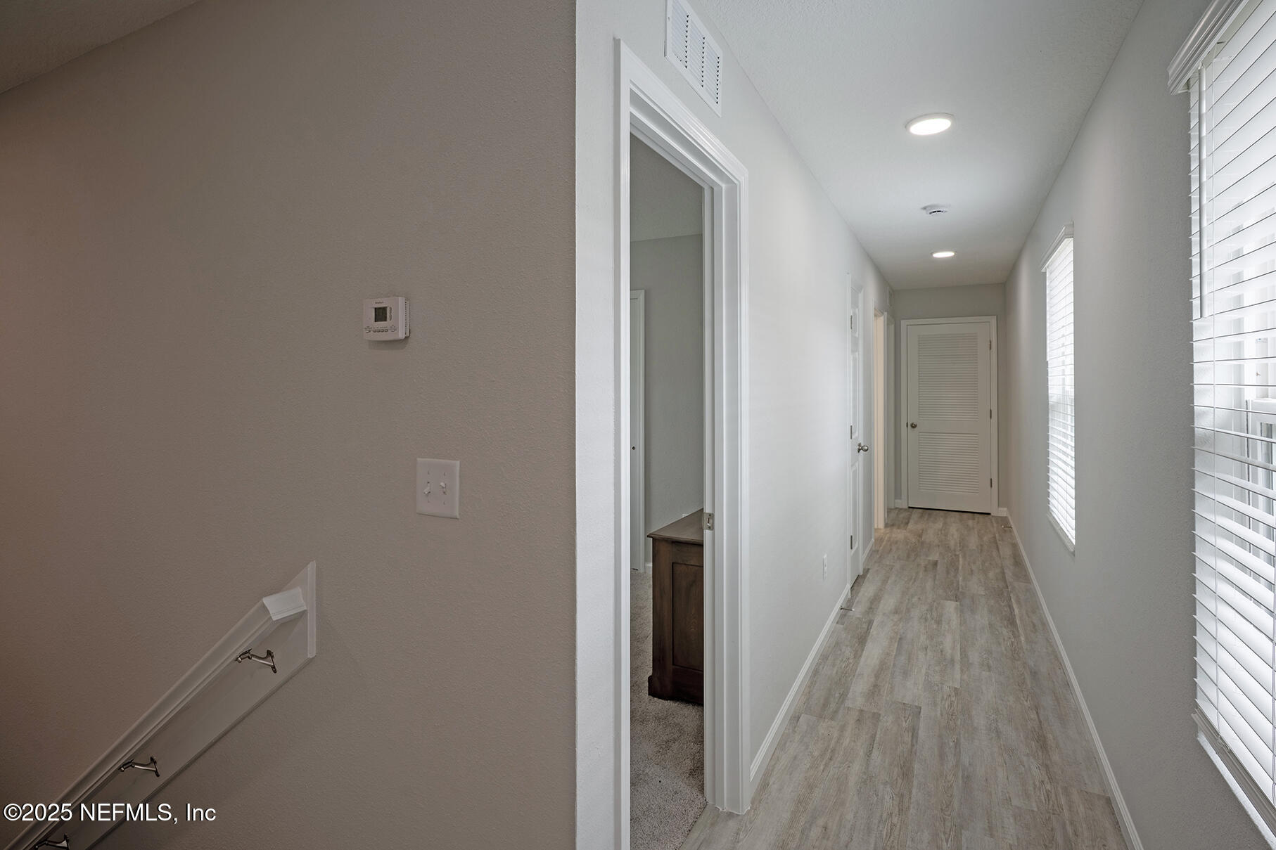 4906 Spring Glen Road Jacksonville, FL 32207 - Photo 31 of 43 a view of a hallway with wooden floor and a window