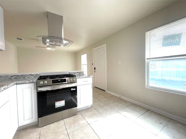 a kitchen with a stove and a sink