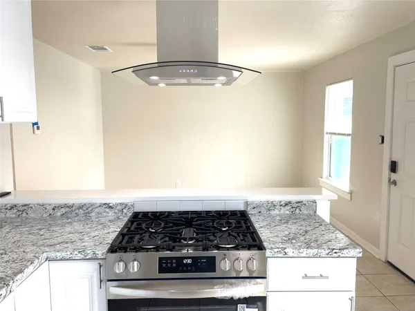a kitchen with granite countertop a sink stainless steel appliances and cabinets