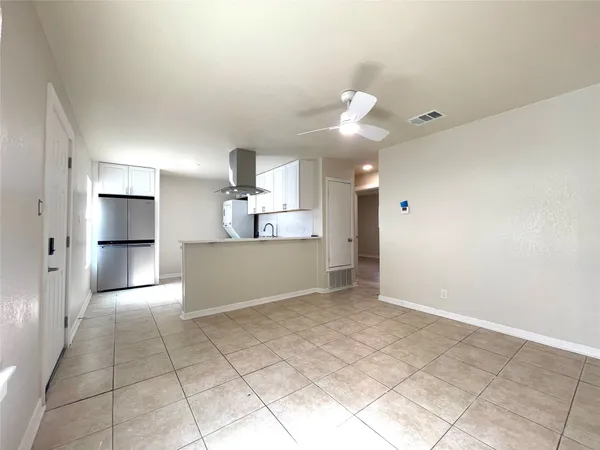 a view of a kitchen with a dishwasher and a refrigerator