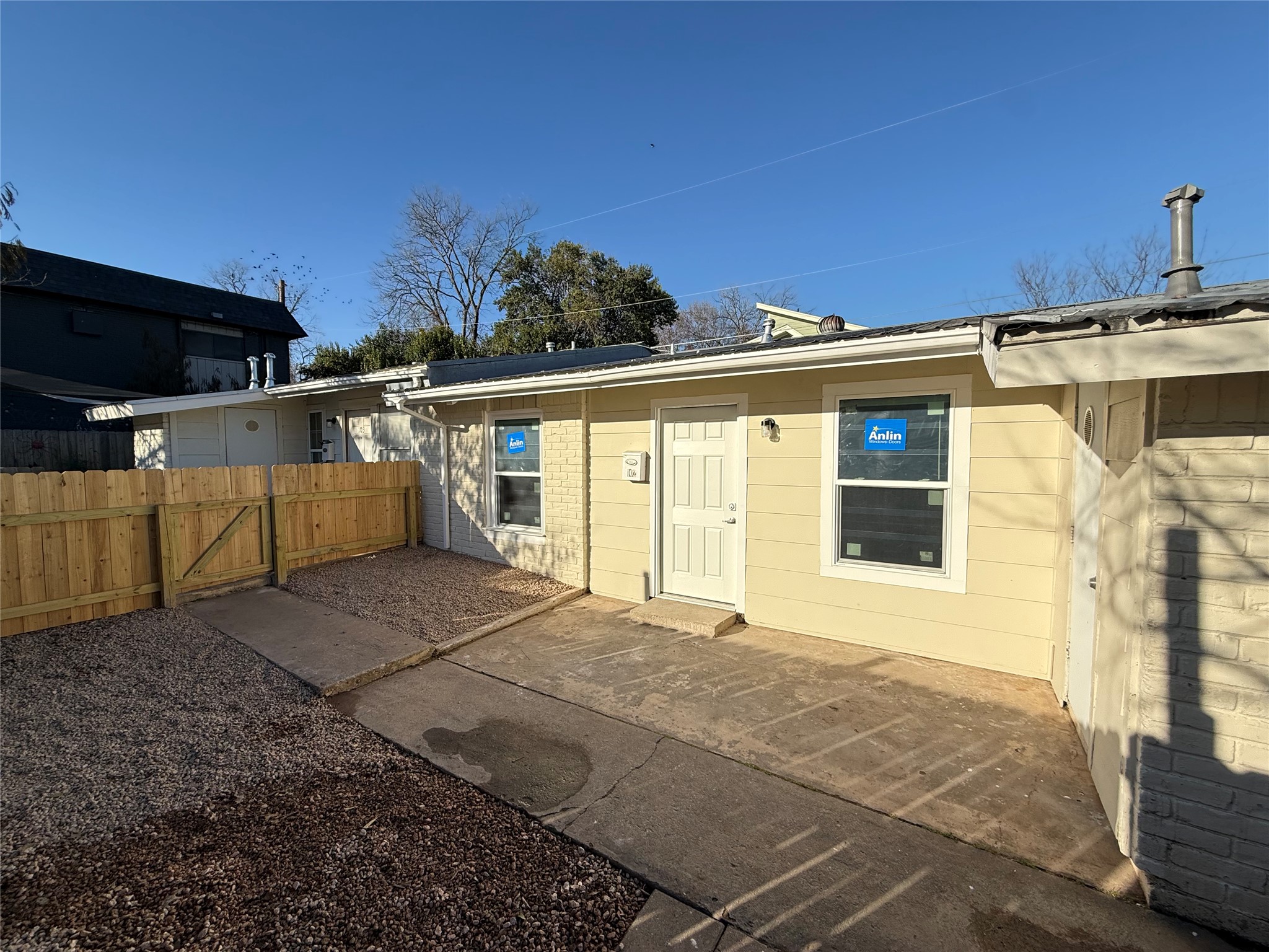 6510 Hickman Avenue, Unit 102 Austin, TX 78723 - Photo 3 of 32 Back of property with a gate and a patio area