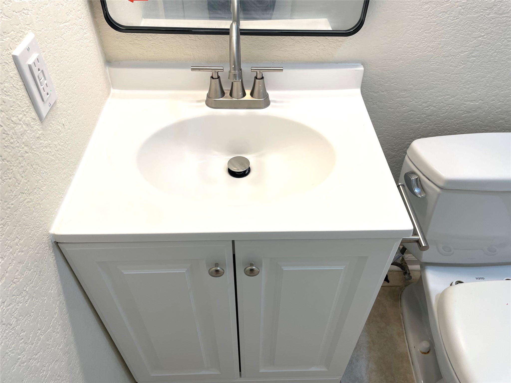6510 Hickman Avenue, Unit 102 Austin, TX 78723 - Photo 31 of 32 Bathroom view of a textured wall and vanity