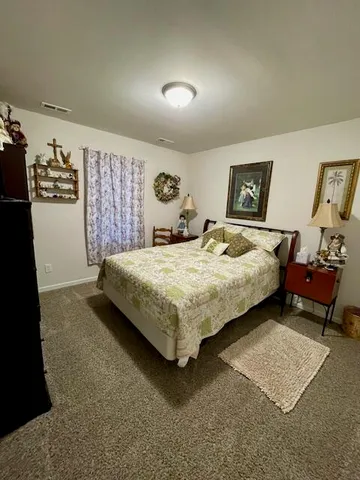 a bedroom with a bed and dresser