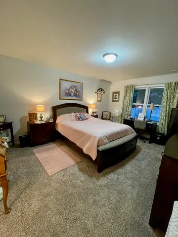 a bedroom with a bed and window