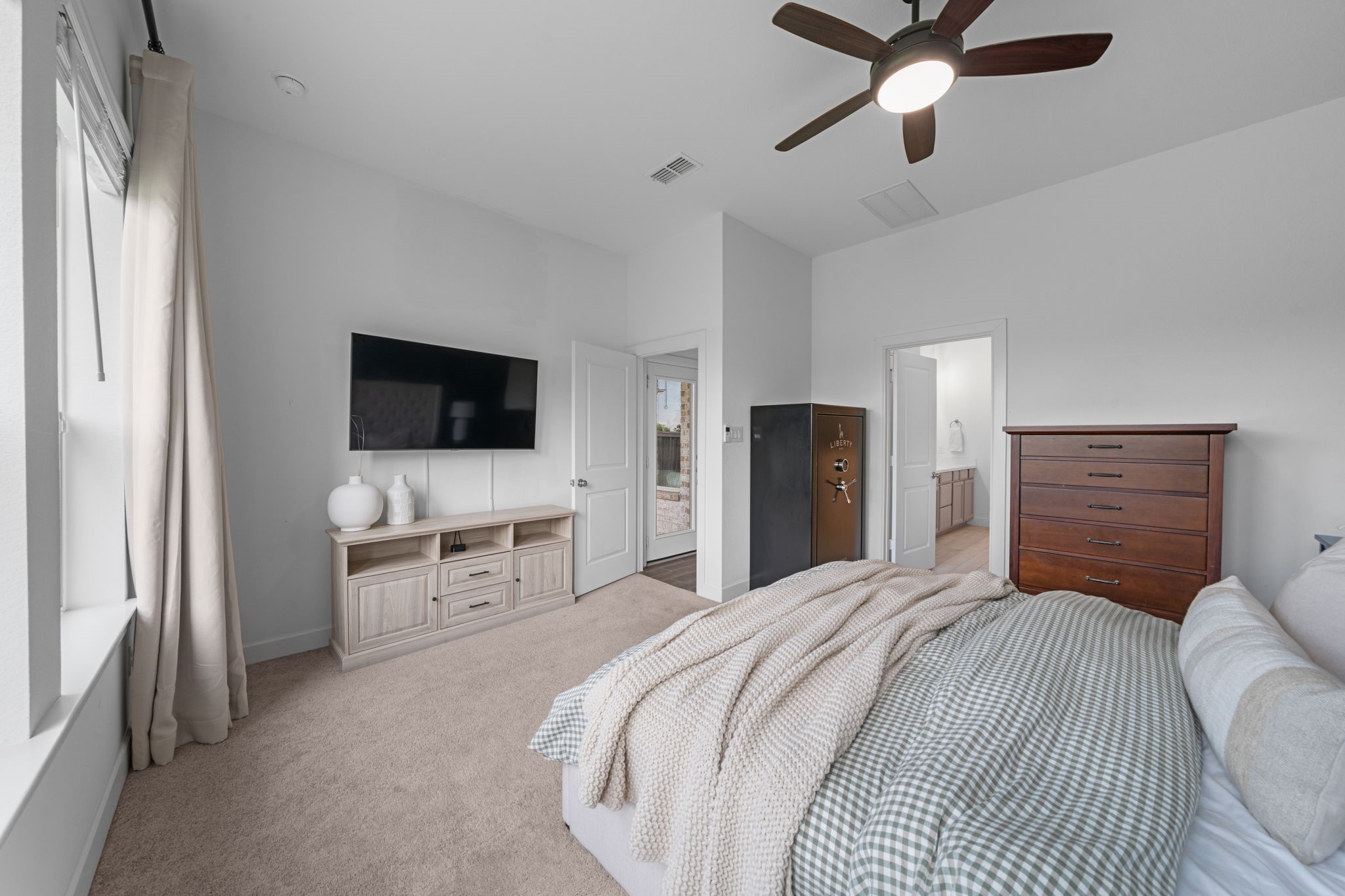 15119 Barbado Ridge Trail Cypress, TX 77433 - Photo 16 of 37 The suite’s thoughtful layout provides plenty of room for a full bedroom set while maintaining an open, uncluttered feel. Just steps away, you’ll find easy access to the en-suite bathroom, offering a private and seamless transition from your morning routine to your evening wind-down.