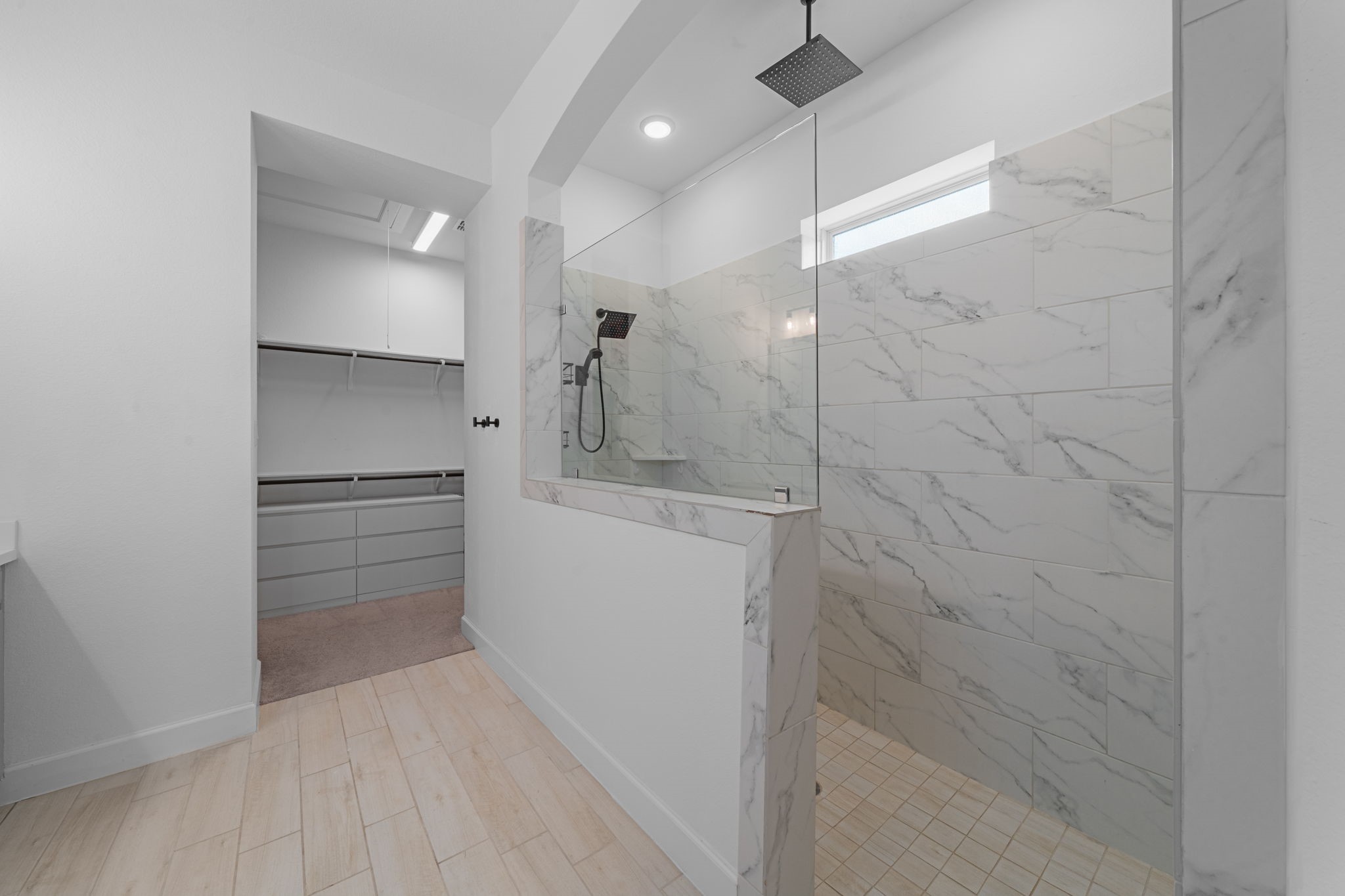 15119 Barbado Ridge Trail Cypress, TX 77433 - Photo 19 of 37 The true showpiece is the oversized walk-in shower, encased in stunning floor-to-ceiling marble-patterned tile and a sleek glass partition.