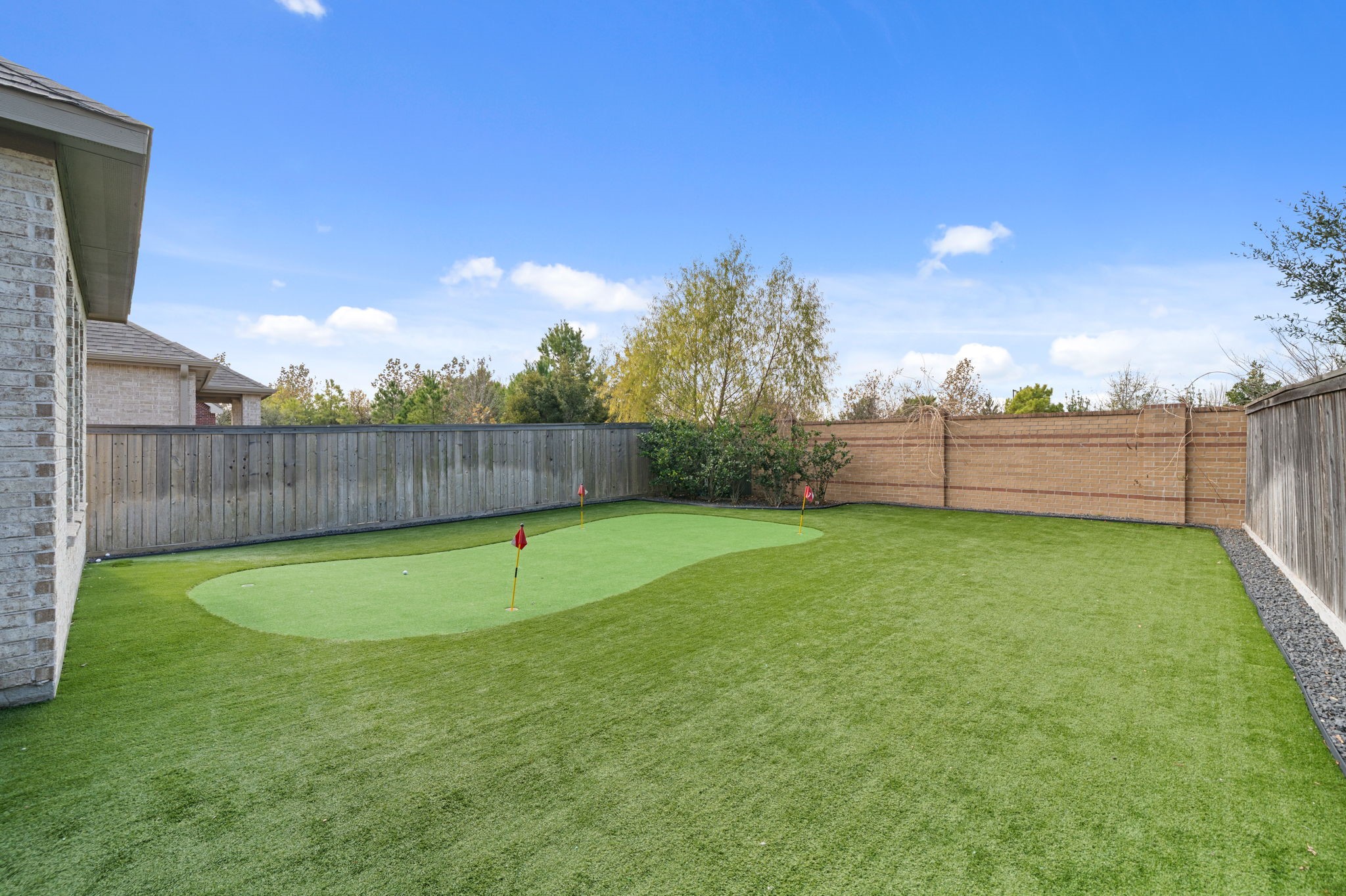 15119 Barbado Ridge Trail Cypress, TX 77433 - Photo 31 of 37 Whether you're a golf enthusiast or just looking for a fun activity for guests, this private green is sure to be a favorite feature. Fully enclosed by a private wooden and brick fence.