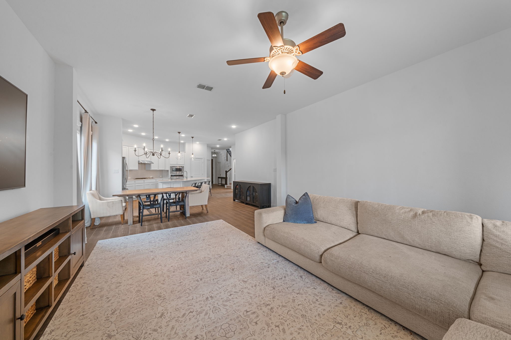 15119 Barbado Ridge Trail Cypress, TX 77433 - Photo 7 of 37 The open-concept layout creates a seamless flow from the living room into the breakfast area and kitchen, making the space feel incredibly airy and connected.