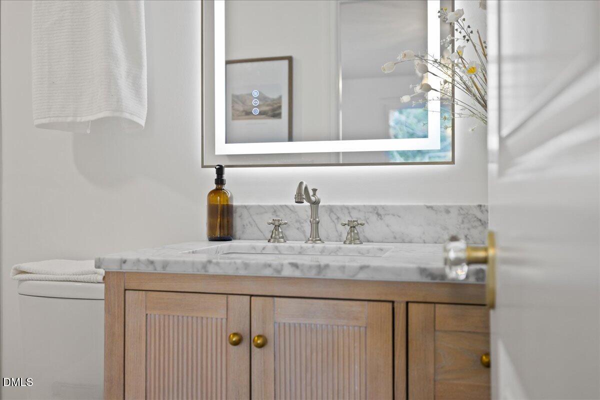 1615 Carbonton Road Sanford, NC 27330 - Photo 31 of 49 a bathroom with a sink and a mirror