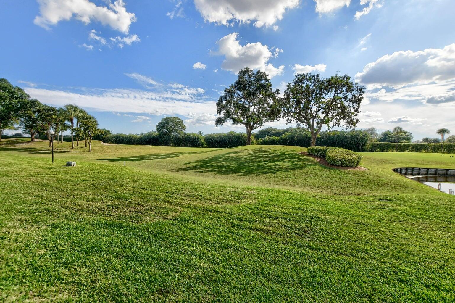 14 Southport Lane, Unit C Boynton Beach, FL 33436 - Photo 11 of 39 a view of a golf course with a lake