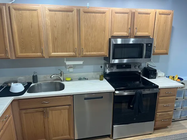 a kitchen with refrigerator and window