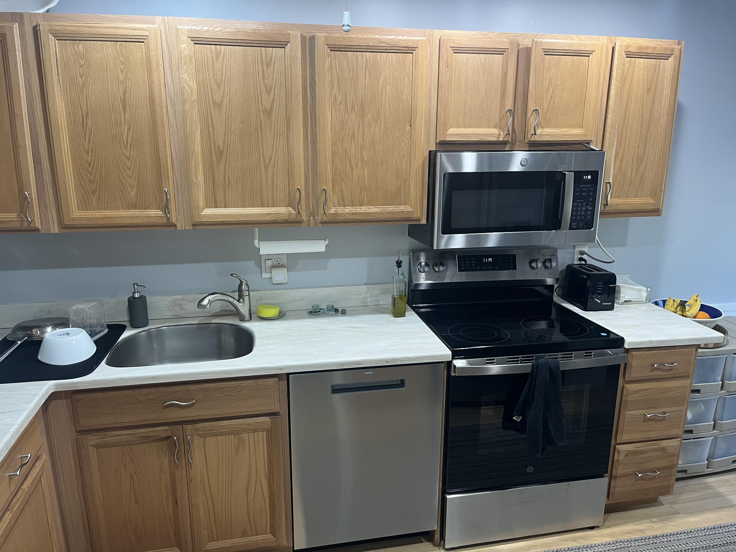 14 Southport Lane, Unit C Boynton Beach, FL 33436 - Photo 12 of 39 a kitchen with a sink stove and cabinets
