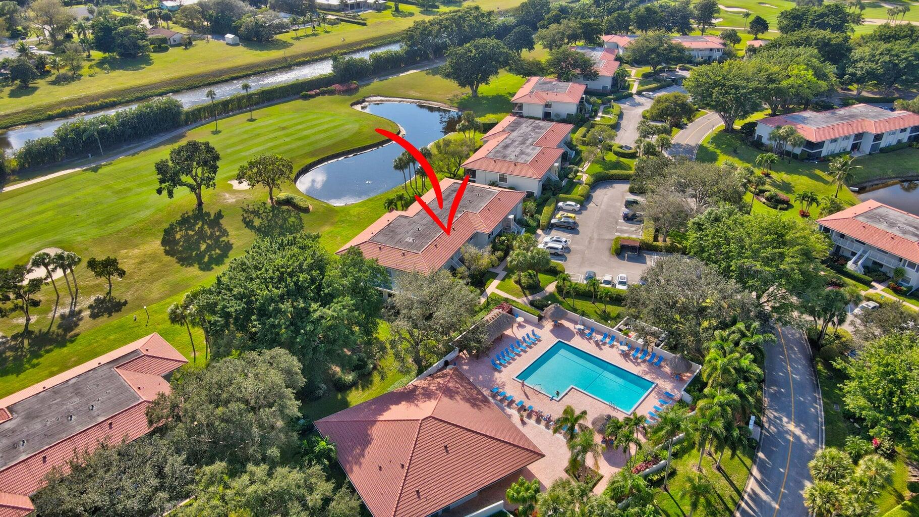 14 Southport Lane, Unit C Boynton Beach, FL 33436 - Photo 18 of 39 an aerial view of a house with a yard and tennis court