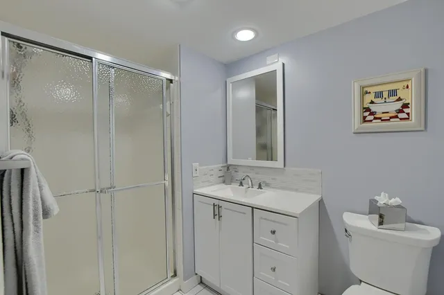 a bathroom with a sink toilet and mirror