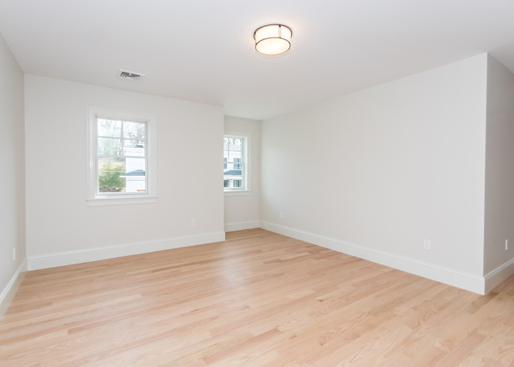 50 Nardone Road Needham, MA 02492 - Photo 26 of 37 an empty room with wooden floor and windows