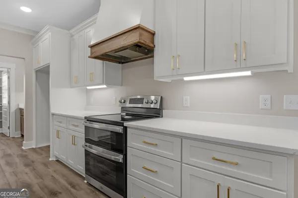 a kitchen with white cabinets and white appliances