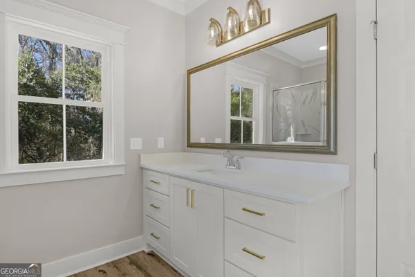 a bathroom with a sink mirror and window