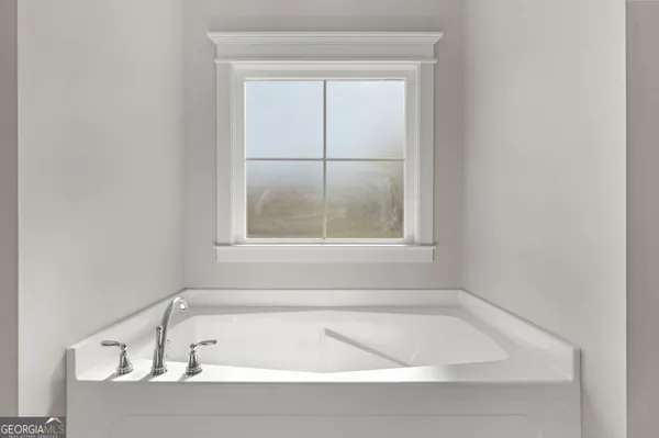a white bath tub sitting next to a window