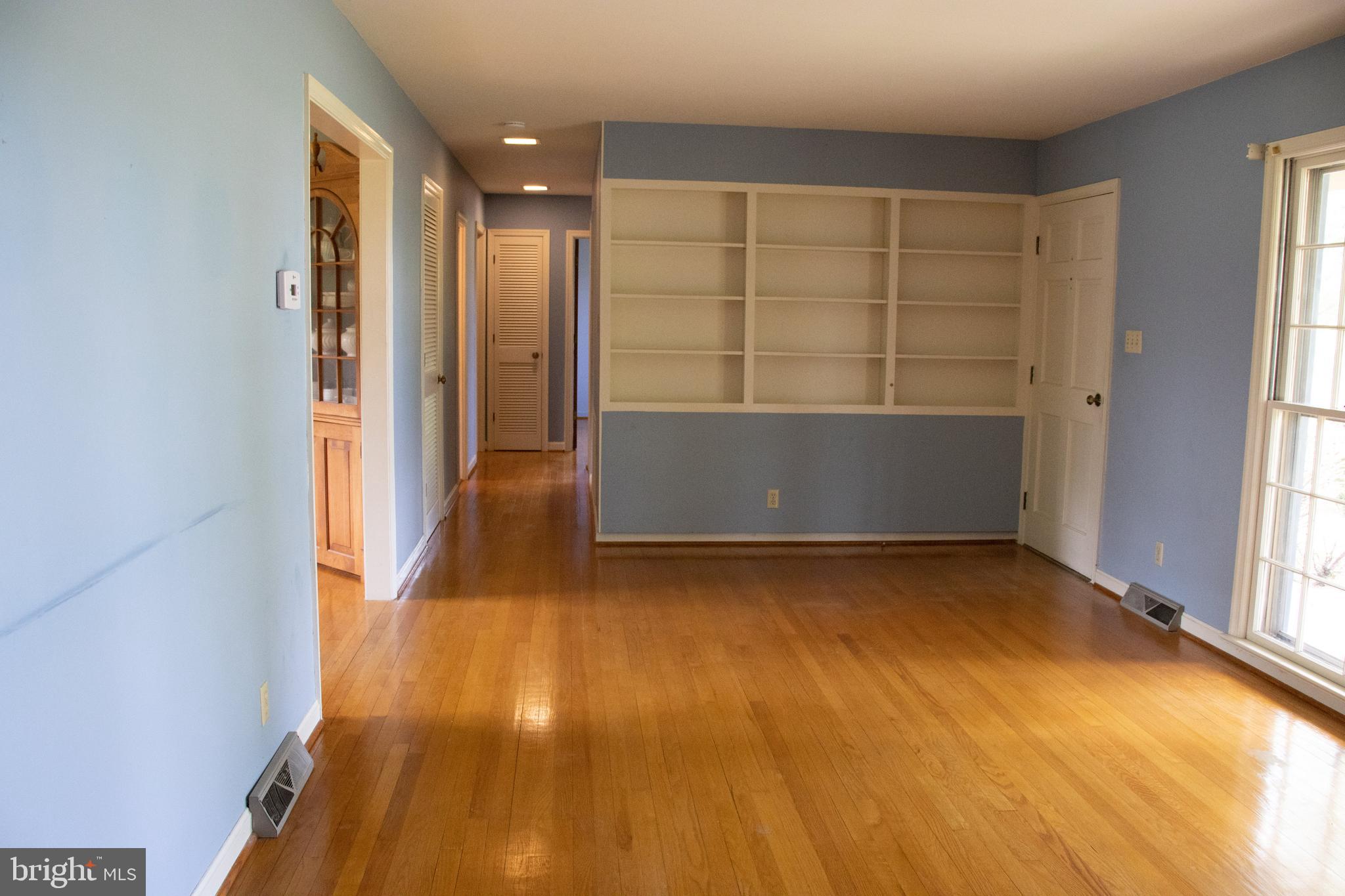 12212 Orange Plank Road Locust Grove, VA 22508 - Photo 16 of 76 Living room with custom built-in shelving