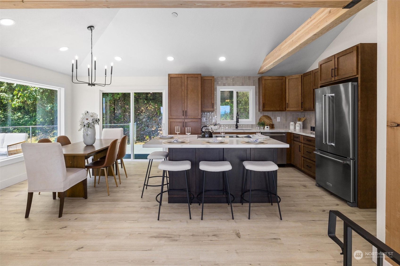 6314 Larimer Road Everett, WA 98208 - Photo 14 of 40 a dining hall with stainless steel appliances kitchen island granite countertop a dining table chairs refrigerator and sink