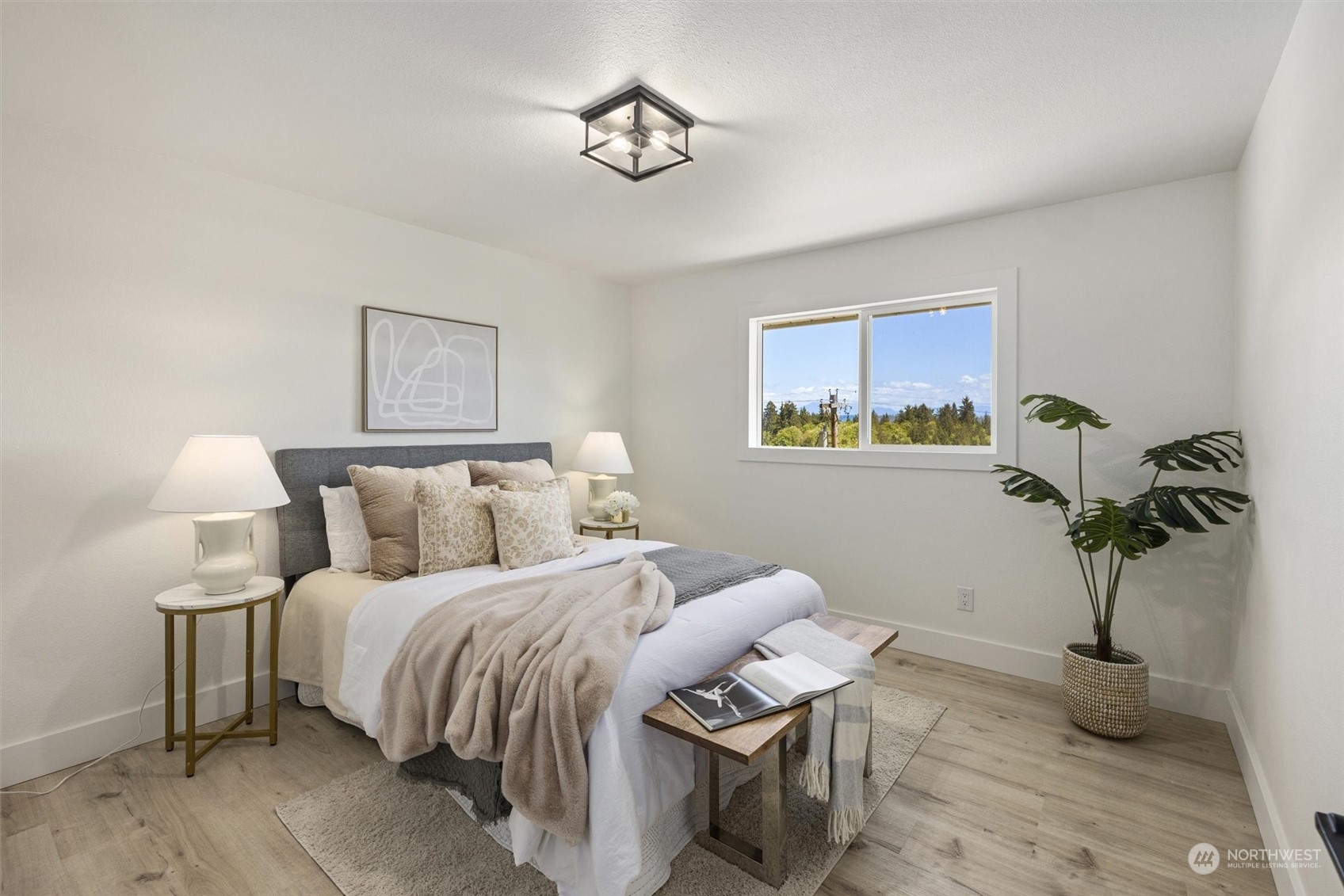 6314 Larimer Road Everett, WA 98208 - Photo 18 of 40 a bedroom with bed and a chandelier
