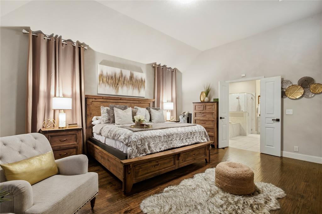 1802 Roundtree Road Forney, TX 75126 - Photo 22 of 39 a spacious bedroom with a bed a couch and dresser
