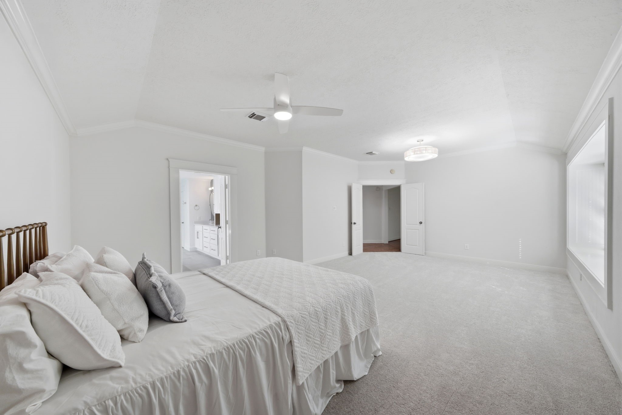 158 Lattice Gate Street Spring, TX 77382 - Photo 5 of 35 High ceilings and neutral tones create a serene atmosphere in the primary suite, which offers enough floor space for a private sitting area or personal retreat. The room flows seamlessly into a spa-inspired ensuite bath and features an expansive walk-in closet for ample storage. Large windows allow natural light to fill the space, enhancing the airy feel of this well-appointed sanctuary.