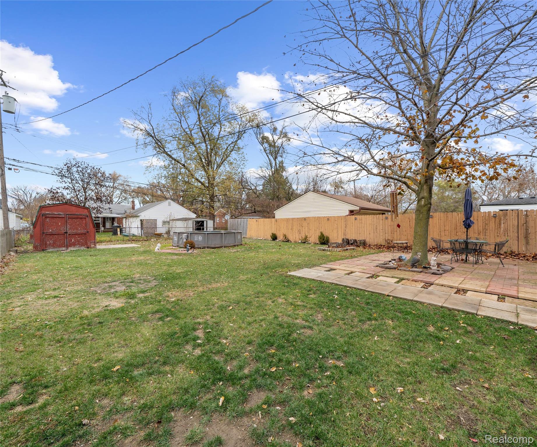 28940 Grandview Street Inkster, MI 48141 - Photo 41 of 41 Fenced backyard with a storage unit and a patio