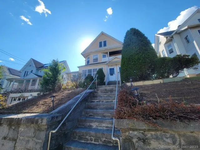 a front view of house with yard and green space
