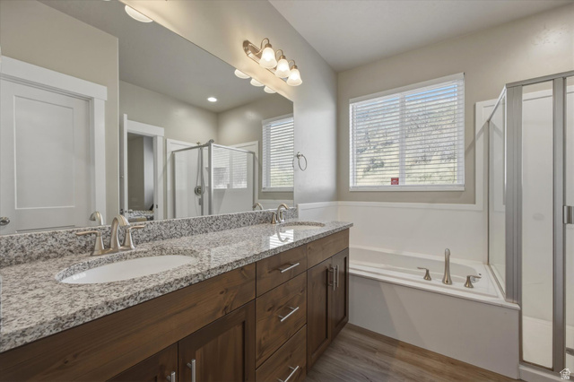 45 Memory Lane Tooele, UT 84074 - Photo 16 of 30 Full bath featuring a stall shower, double vanity, a garden tub, and light wood-type flooring