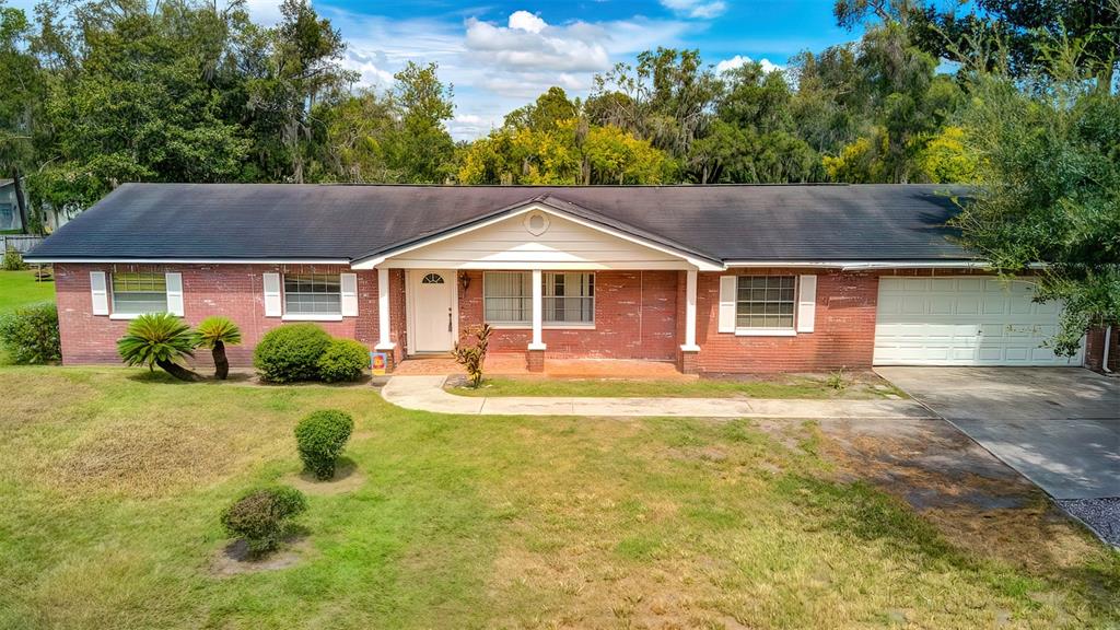 1210 Sunset Lane Lutz, FL 33549 - Photo 1 of 42 a white house that has a tree in it