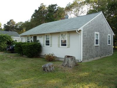 107 Lincoln Road Hyannis, MA 02601 - Photo 1 of 29 a backyard of a house with table and chairs