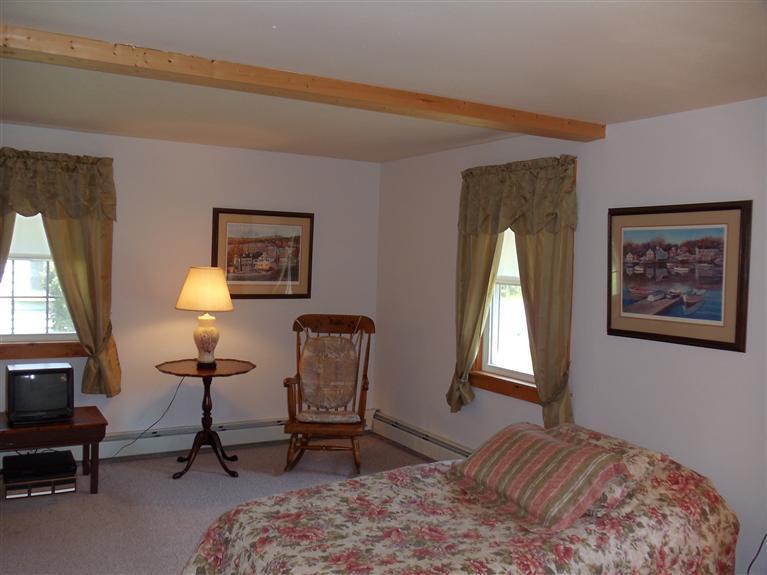 107 Lincoln Road Hyannis, MA 02601 - Photo 24 of 29 a bedroom with a bed a lamp on desk and a window