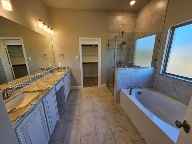 a bathroom with a bathtub and shower