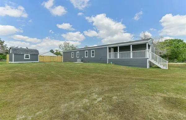 a view of a house with a backyard