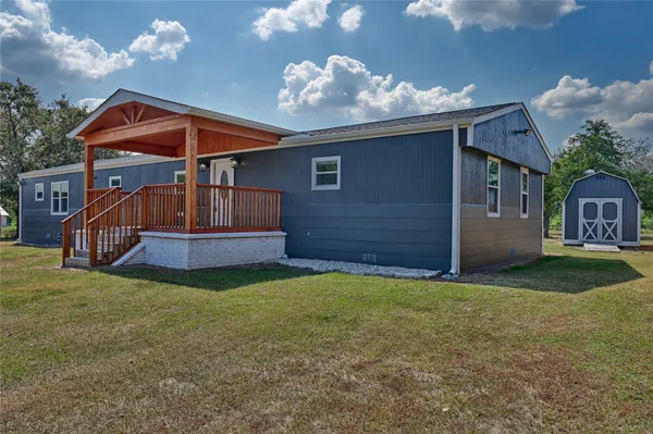 a view of a big yard with large trees