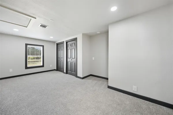 a view of a livingroom with an empty space and a window