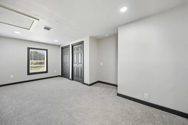 a kitchen with white cabinets and sink