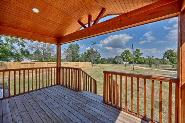 a balcony with wooden floor in front of it