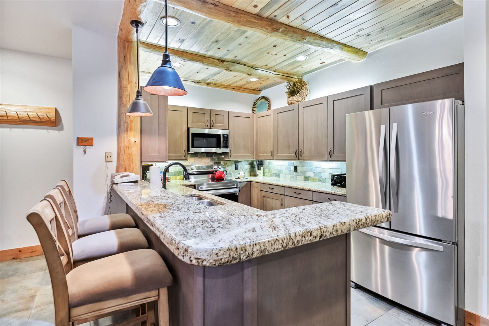 1201 West Keystone Road, Unit 2724 Keystone, CO 80435 - Photo 6 of 28 Kitchen with stainless steel appliances, kitchen peninsula, a breakfast bar area, sink, and pendant lighting