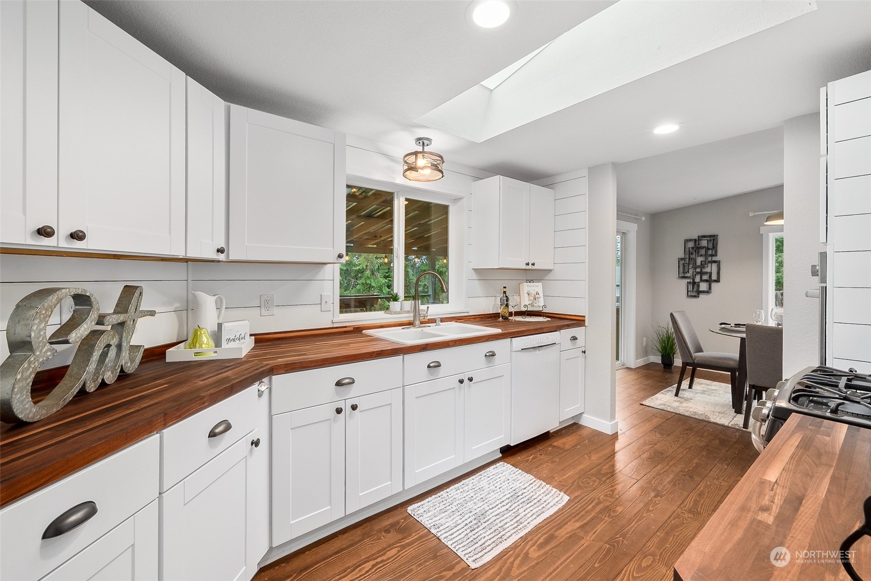 661 Brockway Road Chehalis, WA 98532 - Photo 13 of 40 a large white kitchen with stainless steel appliances granite countertop a sink dishwasher a stove and white cabinets with wooden floor